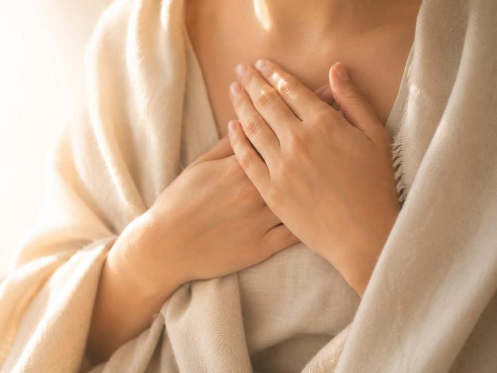 A hand resting over the heart